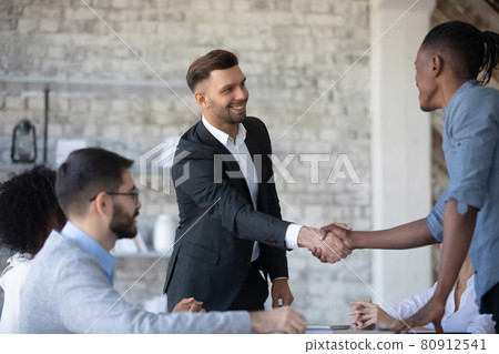 Smiling diverse businesspeople handshake at office meeting 80912541