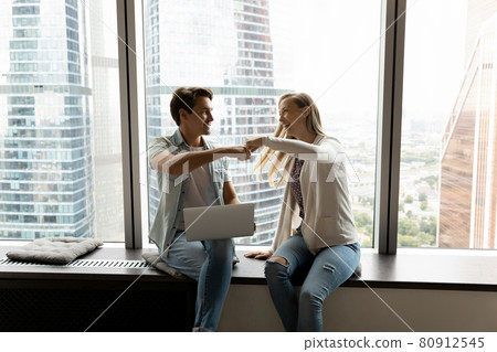 Happy business teammates, office friends, buddies giving fist bump Happy business teammates, office friends, buddies giving fist bump 80912545