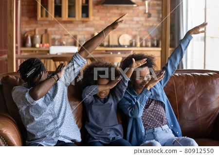 Smiling biracial parents with daughter dab dance Smiling biracial parents with daughter dab dance 80912550