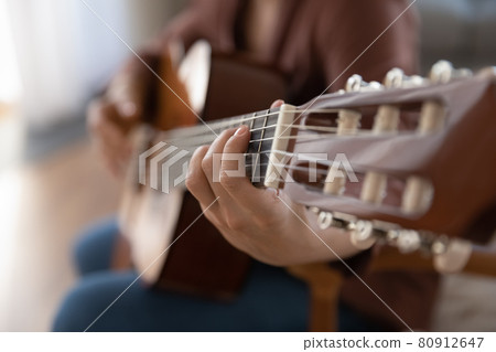 Close up of woman play on guitar Close up of woman play on guitar 80912647