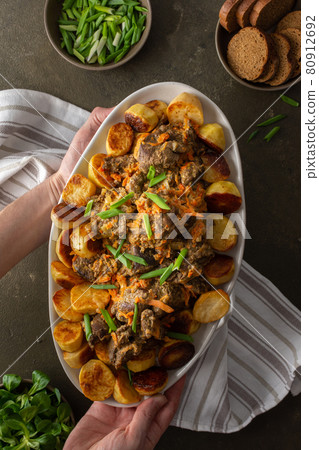 Dish with stewed wild goat and baked potatoes Dish with stewed wild goat and baked potatoes 80912692