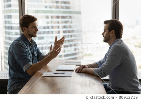 Two businessmen, business partners meeting in office for negotiation Two businessmen, business partners meeting in office for negotiation 80912719
