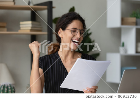 Close up overjoyed businesswoman in glasses celebrating achievement, reading letter 80912736