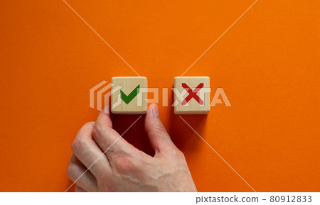 Close up customer hand choose yes no icon on wood cubes. Service rating, satisfaction concept. Copy space, beautiful orange background. 80912833