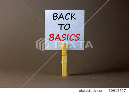 White paper with text 'back to basics', clip on wood clothespin. Beautiful grey background. Business concept. Copy space. 80912837