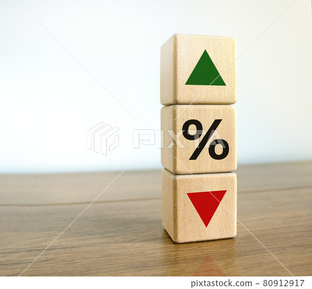 Interest rates symbol. Wooden cubes with the direction of an arrow symbolizing that the interest rates are going down or up. Beautiful wooden table, white background. Business concept. Copy space. Interest rates symbol. Wooden cubes with the direction of an arrow symbolizing that the interest rates are going down or up. Beautiful wooden table, white background. Business concept. Copy space. 80912917