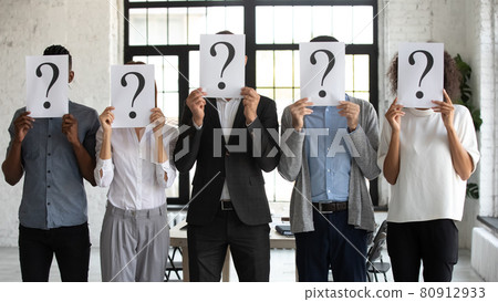 Diverse people hold paper with question mark Diverse people hold paper with question mark 80912933