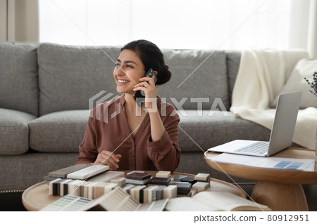 Smiling Indian woman choose block samples for home decoration Smiling Indian woman choose block samples for home decoration 80912951