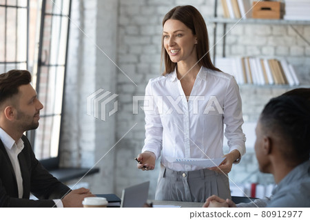 Smiling Caucasian businesswoman lead meeting with employees 80912977