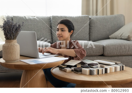 Indian female designer work on computer at home office 80912993