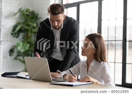 Diverse businesspeople collaborate brainstorm on laptop in office Diverse businesspeople collaborate brainstorm on laptop in office 80912995