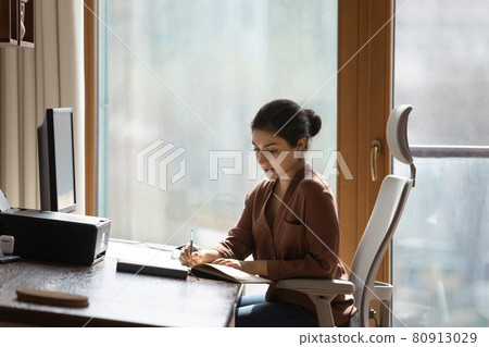 Teen Indian woman write working on computer 80913029