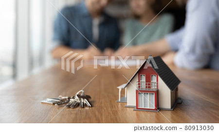 Close up of key and tiny toy house on table Close up of key and tiny toy house on table 80913030