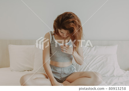 Attractive woman relax after wake up in bedroom. Summer vacation. Attractive woman relax after wake up in bedroom. Summer vacation. 80913258