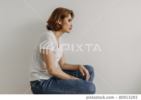 Cool looks woman in white t-shirt and jean relax in her apartment room. Cool looks woman in white t-shirt and jean relax in her apartment room. 80913265