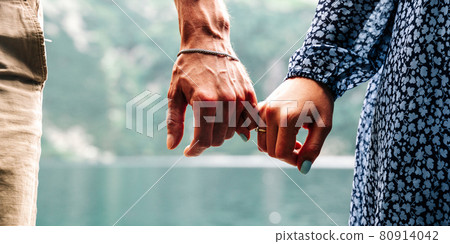 Couple walking. Happy young romantic people holding hands. Love couple man and woman together in summer park. Young family traveling active adventure vacations. 80914042