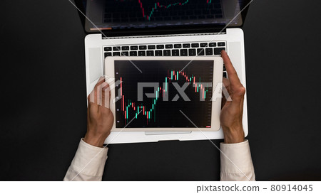 Office desk. Investment business technology app on digital screen. Finance application for sell, buy and analysis profit dividend statistics. Digital information background. 80914045