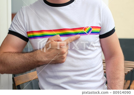 Man in the T shirt with LGBT flag shows on the heart . Gay and lesbian rights concept.  80914090