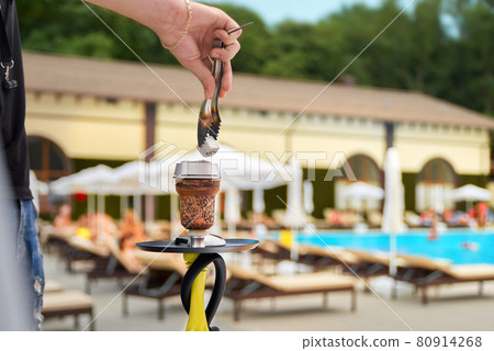 summer rest, smoke party concept - closeup hookah on pool background, resort entertainments summer rest, smoke party concept - closeup hookah on pool background, resort entertainments 80914268