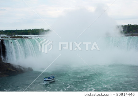NIAGARA FALLS, ONTARIO, CANADA - MAY 20th 2018: Touristic boat on Horseshoe Falls, also known as Canadian Falls NIAGARA FALLS, ONTARIO, CANADA - MAY 20th 2018: Touristic boat on Horseshoe Falls, also known as Canadian Falls 80914446