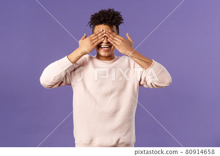 Portrait of surprised and excited, amused happy birthday guy close eyes and count ten to see what friends brought as gift, anticipating present, awaiting with cheerful expression, purple background 80914658