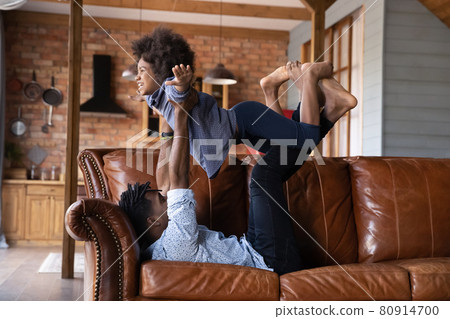 Loving biracial dad play with small daughter at home Loving biracial dad play with small daughter at home 80914700