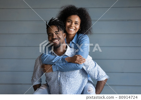 Portrait of happy ethnic couple hugging embracing Portrait of happy ethnic couple hugging embracing 80914724