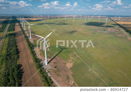 Aerial view of Wind power turbine is a popular sustainable, renewable energy source on beautiful cloudy sky. Wind power turbines generating clean renewable energy for sustainable development. Aerial view of Wind power turbine is a popular sustainable, renewable energy source on beautiful cloudy sky. Wind power turbines generating clean renewable energy for sustainable development. 80914727