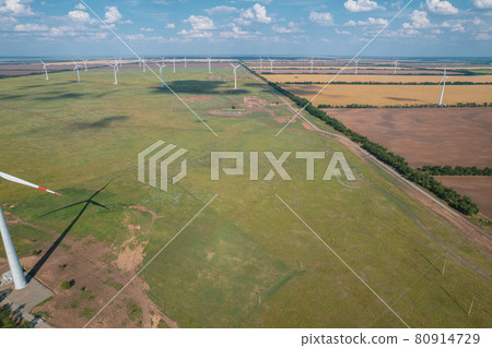Aerial view of Wind power turbine is a popular sustainable, renewable energy source on beautiful cloudy sky. Wind power turbines generating clean renewable energy for sustainable development. Aerial view of Wind power turbine is a popular sustainable, renewable energy source on beautiful cloudy sky. Wind power turbines generating clean renewable energy for sustainable development. 80914729