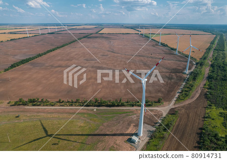 Aerial view of Wind power turbine is a popular sustainable, renewable energy source on beautiful cloudy sky. Wind power turbines generating clean renewable energy for sustainable development. 80914731