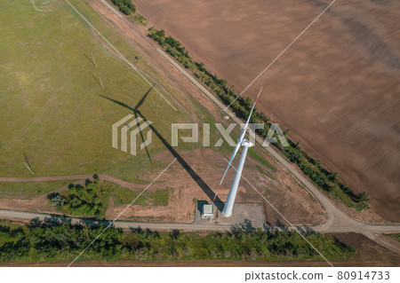 Aerial view of Wind power turbine is a popular sustainable, renewable energy source on beautiful cloudy sky. Wind power turbines generating clean renewable energy for sustainable development. Aerial view of Wind power turbine is a popular sustainable, renewable energy source on beautiful cloudy sky. Wind power turbines generating clean renewable energy for sustainable development. 80914733