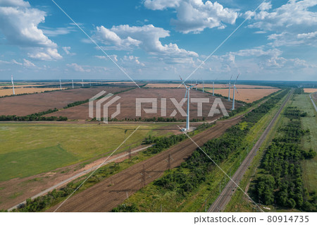 Aerial view of Wind power turbine is a popular sustainable, renewable energy source on beautiful cloudy sky. Wind power turbines generating clean renewable energy for sustainable development. Aerial view of Wind power turbine is a popular sustainable, renewable energy source on beautiful cloudy sky. Wind power turbines generating clean renewable energy for sustainable development. 80914735