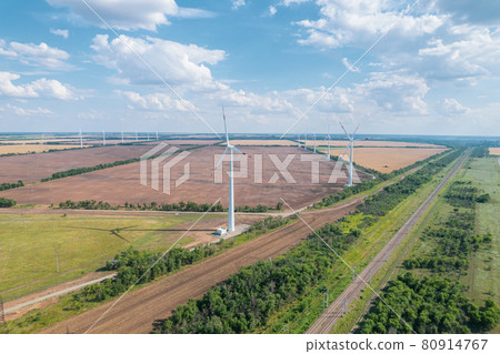Aerial view of Wind power turbine is a popular sustainable, renewable energy source on beautiful cloudy sky. Wind power turbines generating clean renewable energy for sustainable development. 80914767