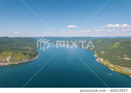 The Angara River in Siberia leaving Lake Baikal near the settlement of Listvyanka. Panoramic aerial view. 80914847