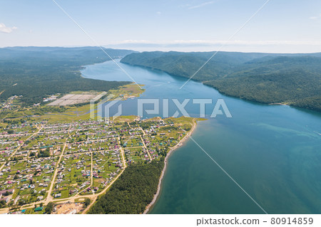 The Angara River is a major river in Siberia leaving Lake Baikal near the settlement of Listvyanka. Panoramic aerial view. 80914859
