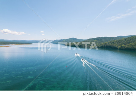 The Angara River is a major river in Siberia leaving Lake Baikal near the settlement of Listvyanka. Panoramic aerial view. 80914864