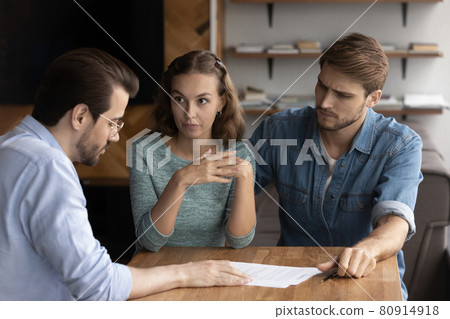 Couple of angry tenants having dispute with real estate agent Couple of angry tenants having dispute with real estate agent 80914918