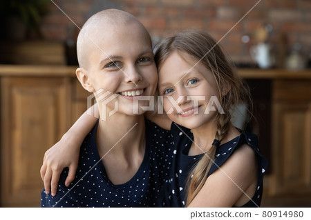 Happy cancer mom and lute little daughter hugging at home Happy cancer mom and lute little daughter hugging at home 80914980