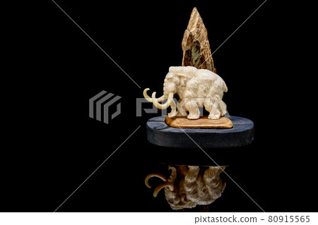 ivory statuette of elephant mammoth on black background ivory statuette of elephant mammoth on black background 80915565