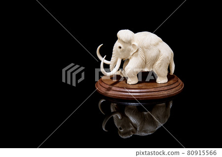 ivory statuette of elephant mammoth on black background ivory statuette of elephant mammoth on black background 80915566