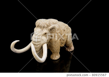 ivory statuette of elephant mammoth on black background ivory statuette of elephant mammoth on black background 80915567