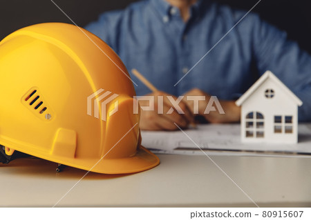Architect engineer working on blueprint at his office Architect engineer working on blueprint at his office 80915607