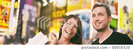 New York city night biracial couple walking on Times Square laughing banner panoramic people lifestyle New York city night biracial couple walking on Times Square laughing banner panoramic people lifestyle 80916320