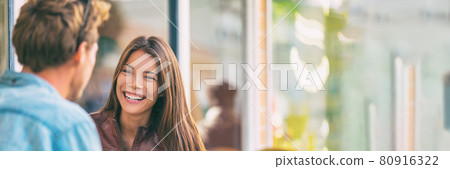 Happy couple talking laughing friends conversation outdoor city lifestyle panorama banner background. Asian girl smiling at man on date 80916322