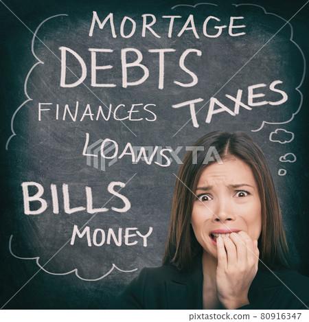 Financial stress Asian woman stressed with money problems bad credit, loans, debts, mortgage payments. Bills to pay worried person on black chalkboard with finance words written 80916347