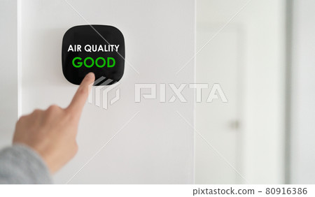 Indoor home air quality smart home domotic automation system. Woman touching touchscreen verifying air purifier filter at GOOD green level banner. Indoor home air quality smart home domotic automation system. Woman touching touchscreen verifying air purifier filter at GOOD green level banner. 80916386