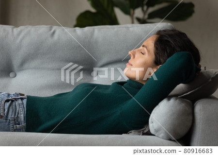 Close up profile peaceful young woman sleeping on cozy sofa Close up profile peaceful young woman sleeping on cozy sofa 80916683