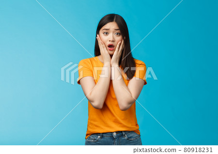 Shocked concerned young asian girl look empathy camera, gasping open mouth worried, frowning upset hear frustrating news, pitty feel sorry for friend, touch cheeks speechless, stand blue background Shocked concerned young asian girl look empathy camera, gasping open mouth worried, frowning upset hear frustrating news, pitty feel sorry for friend, touch cheeks speechless, stand blue background 80918231