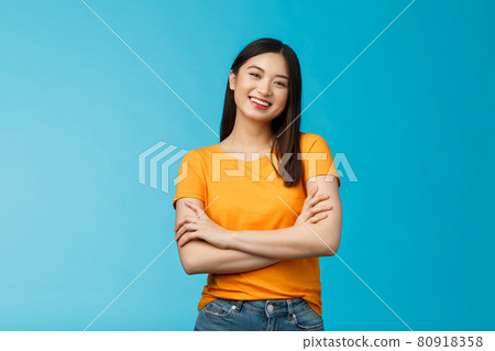Cheerful friendly asian woman with dark short haircut smiling broadly enthusiastic conversation, talking you casually, cross arms chest confident pose, laughing carefree, stand blue background Cheerful friendly asian woman with dark short haircut smiling broadly enthusiastic conversation, talking you casually, cross arms chest confident pose, laughing carefree, stand blue background 80918358