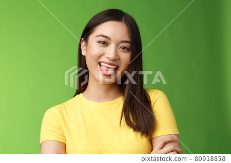 Close-up silly cute flirty asian girl fool around childish, playfully communicate boyfriend, show tongue smiling broadly, cross hands chest casually, enjoy summer holidays, green background Close-up silly cute flirty asian girl fool around childish, playfully communicate boyfriend, show tongue smiling broadly, cross hands chest casually, enjoy summer holidays, green background 80918858